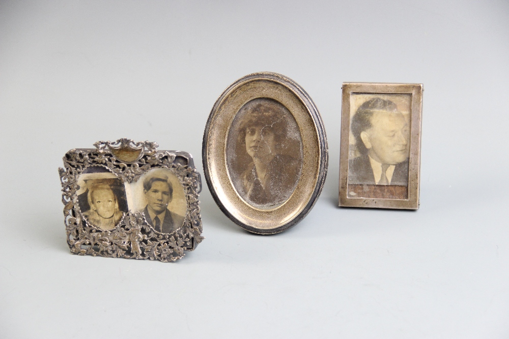 A silver mounted photograph frame, Birmingham 1910, of oval form with oak back and easel support,