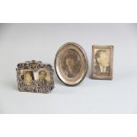 A silver mounted photograph frame, Birmingham 1910, of oval form with oak back and easel support,