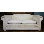 A pair of contemporary Chesterfield type settees, in white fabric, the padded scroll arms