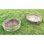 Two reconstituted stone circular troughs, each of shallow weathered form, 22cm H x 92cm D and 22cm H