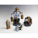 A Chinese pottery model of a Chinese farmer, with rice hat and yoke suspending two baskets, 32cm