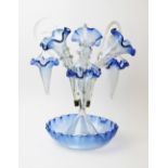 A Victorian glass epergne, mid 19th century, the blue glass base with piecrust rim and central brass