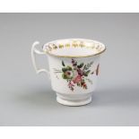 An early 19th century Welsh porcelain coffee cup, probably Swansea, the cup with flared rim, stepped