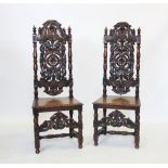 A pair of 17th century style oak hall chairs, late 19th century, each with a carved scrolling