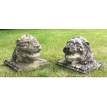 A pair of reconstituted stone lions masks/heads, each on square back, 29cm H x 30cm square (2)