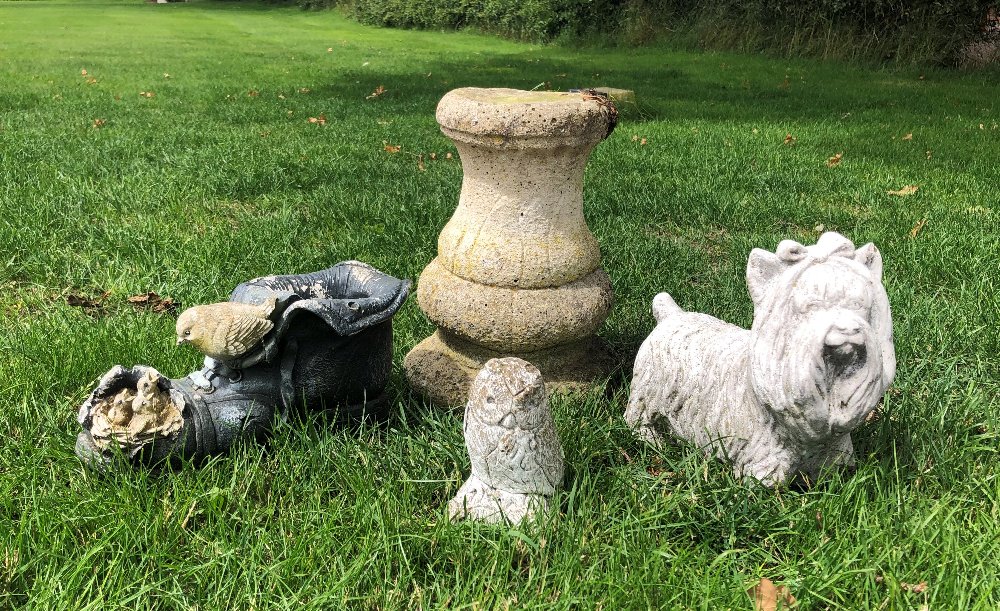 Four garden ornaments to include, a bird feeding her young in a boot, 15cm high, a Yorkshire