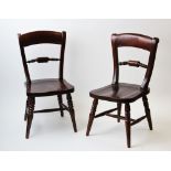 A pair of mahogany Victorian style dolls chairs, each with a rail back above a shaped seat, raised