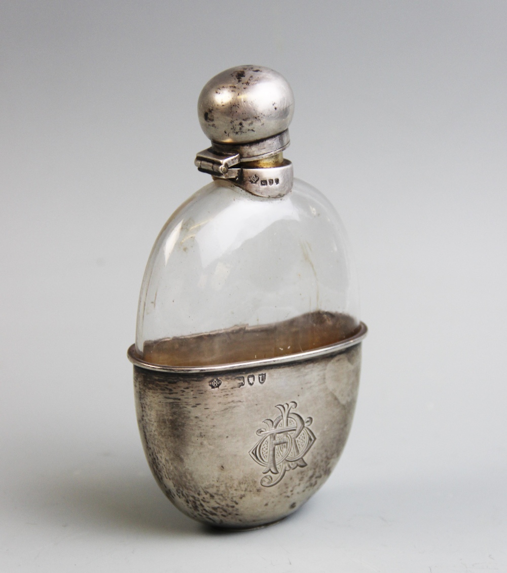 A Victorian silver mounted hip flask, William Hutton & Sons, London 1896, the oval flask mounted