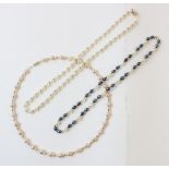 A pink pearl choker, comprising a single strand of off-round pink cultured pearls, interspersed with