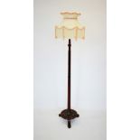 A Regency style mahogany lamp standard, the reeded column with carved ribbon detail, upon a circular