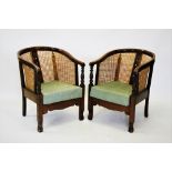 A pair of early 20th century stained beech wood rattan tub chairs, the horse shoe shaped top rail,