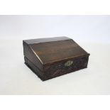 A late 17th/early 18th century oak bible box, the hinged sloping lid enclosing a compartmentalised