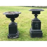 A large cast iron black painted classical urn on pedestal base, the urn with cast fluted detail,