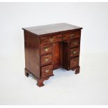 A George III mahogany knee hole desk, the rectangular top above two frieze drawers and a central