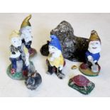 A collection of garden gnomes, two animals and a dog