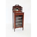 An Edwardian mahogany music cabinet, the raised architectural back with a twin swan neck pediment