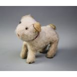 A late 19th/early 20th century straw stuffed dog, wire framed, modelled standing with plush