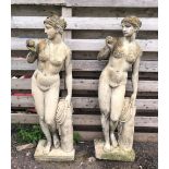 Two large female garden statues, each modelled standing contrapposto beside a trunk, 145cm H (2)