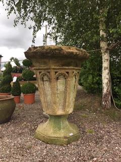 A large pair of reconstituted stone jardinieres/planters of Gothic design, each of octagonal