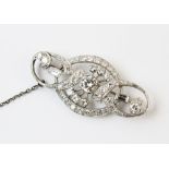 An Art Deco diamond set brooch, the central round brilliant diamond measuring approx. 0.70cts,