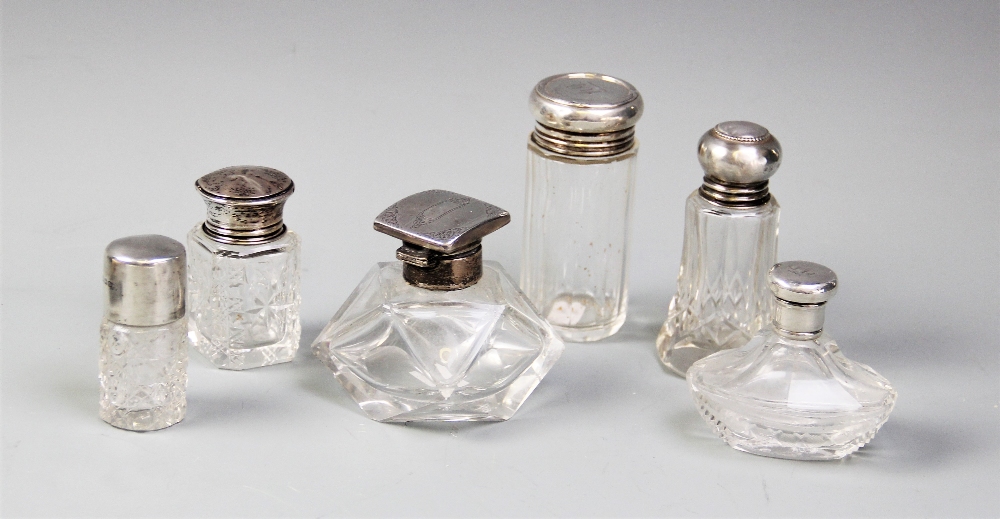 Six assorted glass and silver topped dressing table jars, to include a faceted square example,