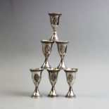 A set of six silver Middle Eastern liqueur cups, of tapering form, each decorated with stylized