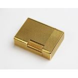 A Dupont of Paris gold plated lighter, of rectangular form with engine turned decoration to