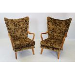 A pair of mid 20th century HK open armchairs, designed by Howard Keith, with padded wing backs and