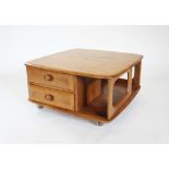 An Ercol 'Pandora' light elm coffee table, the two tier square table with two drawers, raised upon