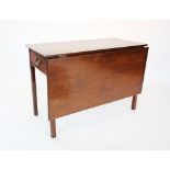 A George III mahogany single drop leaf table, the rectangular top above a single frieze drawer,