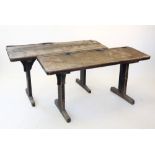 A near pair of 19th century painted pine school desks, each with a sloping slab top carved with