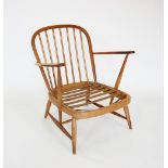 A mid 20th century Ercol light beech wood open armchair, the stick back extending to out swept arms,