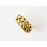 A gent's 18ct gold ring, the woven design ring with applied beaded decoration, continuing to split