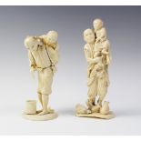 A Japanese carved ivory okimono, Meiji period (1868 - 1912), modelled as a father and child standing