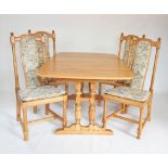 A late 20th century Ercol blonde elm extending dining table with four chairs, the rectangular