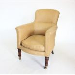 A Victorian tub chair, with a padded back rest and padded arms enclosing the cushion seat, raised