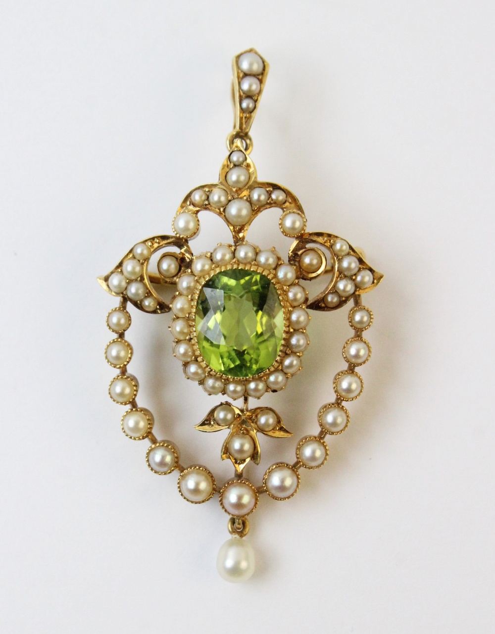 An Edwardian style peridot and seed pearl pendant/brooch, the central oval mixed cut peridot - Image 2 of 3