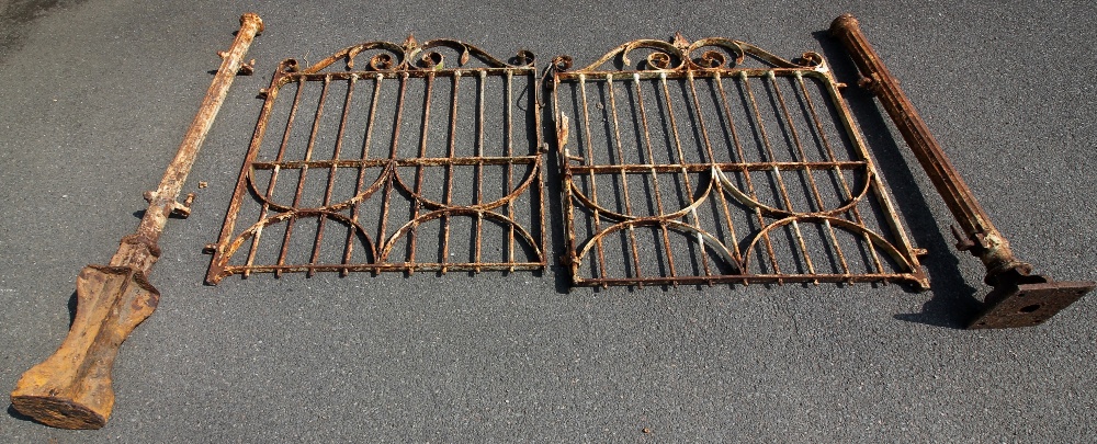 A pair of 19th century wrought iron gates and two gate posts, each gate with a spear finial above