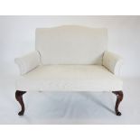 An Edwardian style two seater sofa of small proportions, the serpentine padded back