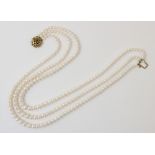 A cultured pearl necklace with 9ct gold clasp, comprising three rows of graduated round cultured