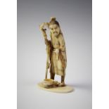 A Japanese carved ivory okimono, Meiji period (1868 - 1912), modelled as a sage supported by a