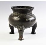 A 19th century Chinese bronze tripod censer, of circular form in an archaic design raised on three