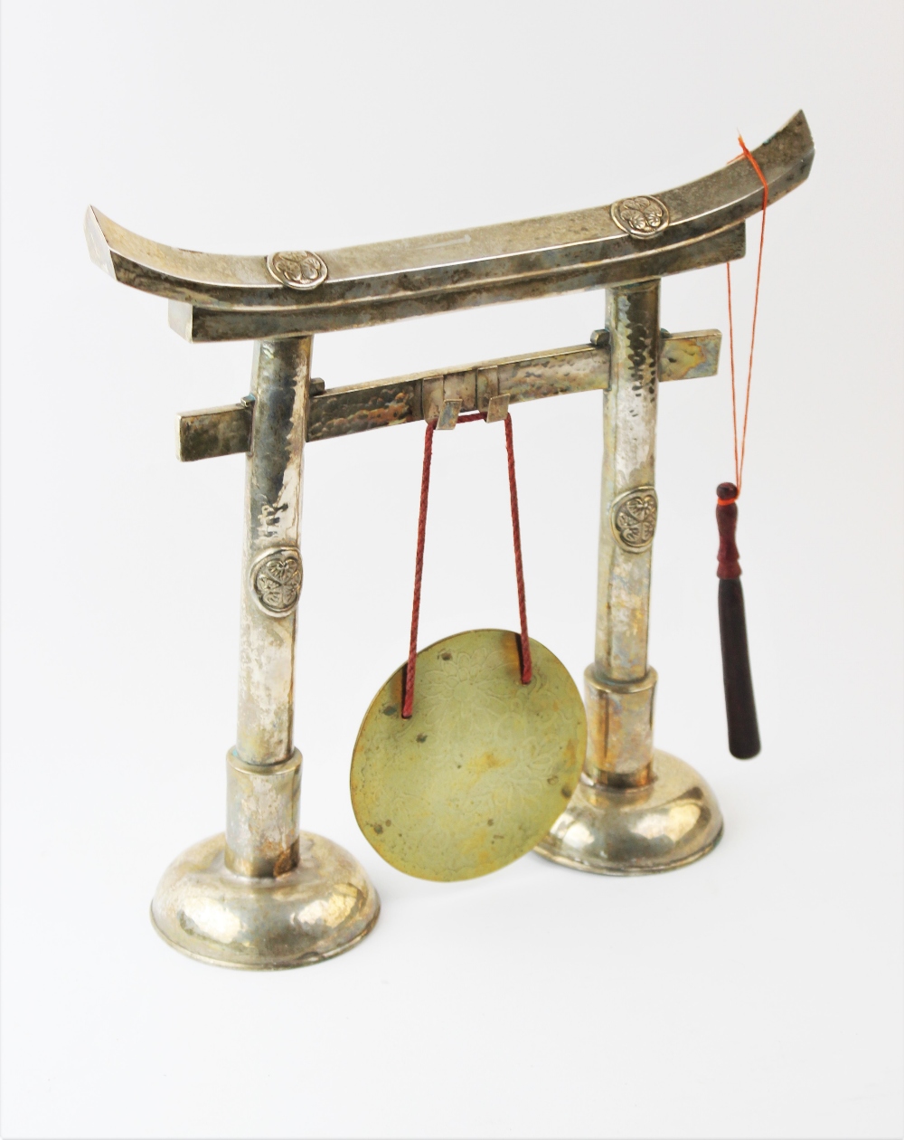 A large white metal Chinese dinner gong, modelled as a paifang suspending a polished brass plate, - Image 2 of 2