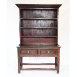 An 18th century oak Welsh dresser, the moulded cornice above three shelves, upon the base with a