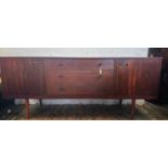 A mid-century teak sideboard, of Danish minimalist design, with three drawers