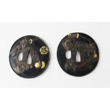 Two Japanese bronze parcel gilt samurai Tsuba, each of circular form and relief moulded with a