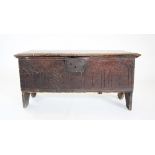 A 17th century oak six plank coffer, the rectangular moulded top on later hinges, above a front