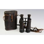 A pair of WWII 'Busch Prisma-Binocle' binoculars, leather clad with cranked barrels, inscribed '