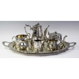 A four-piece silver plated tea service, comprising; a teapot, hot water jug, sugar bowl and milk