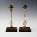 A pair of late Victorian cut glass and ormolu mounted lamp bases, each of slender baluster form with